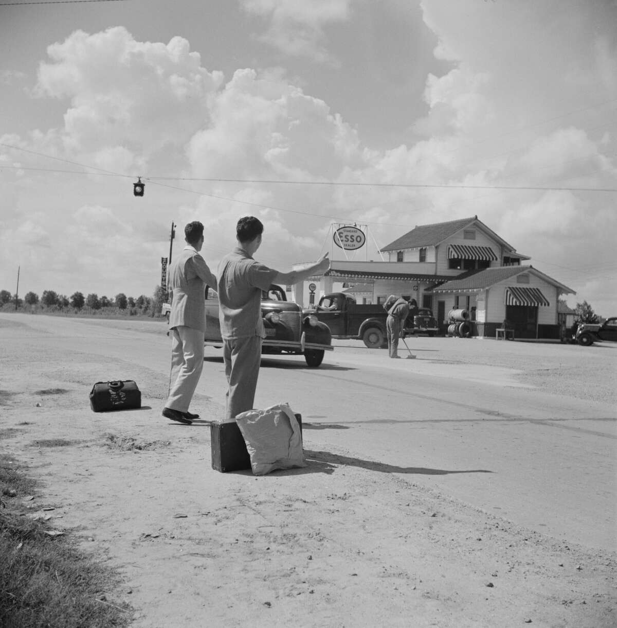 Two young men hitchhiking, near Natchitoches, Louisiana, Marion Post Wolcott for Farm Security Administration, June 1940. (Photo by: Universal History Archive/Universal Images Group via Getty Images)