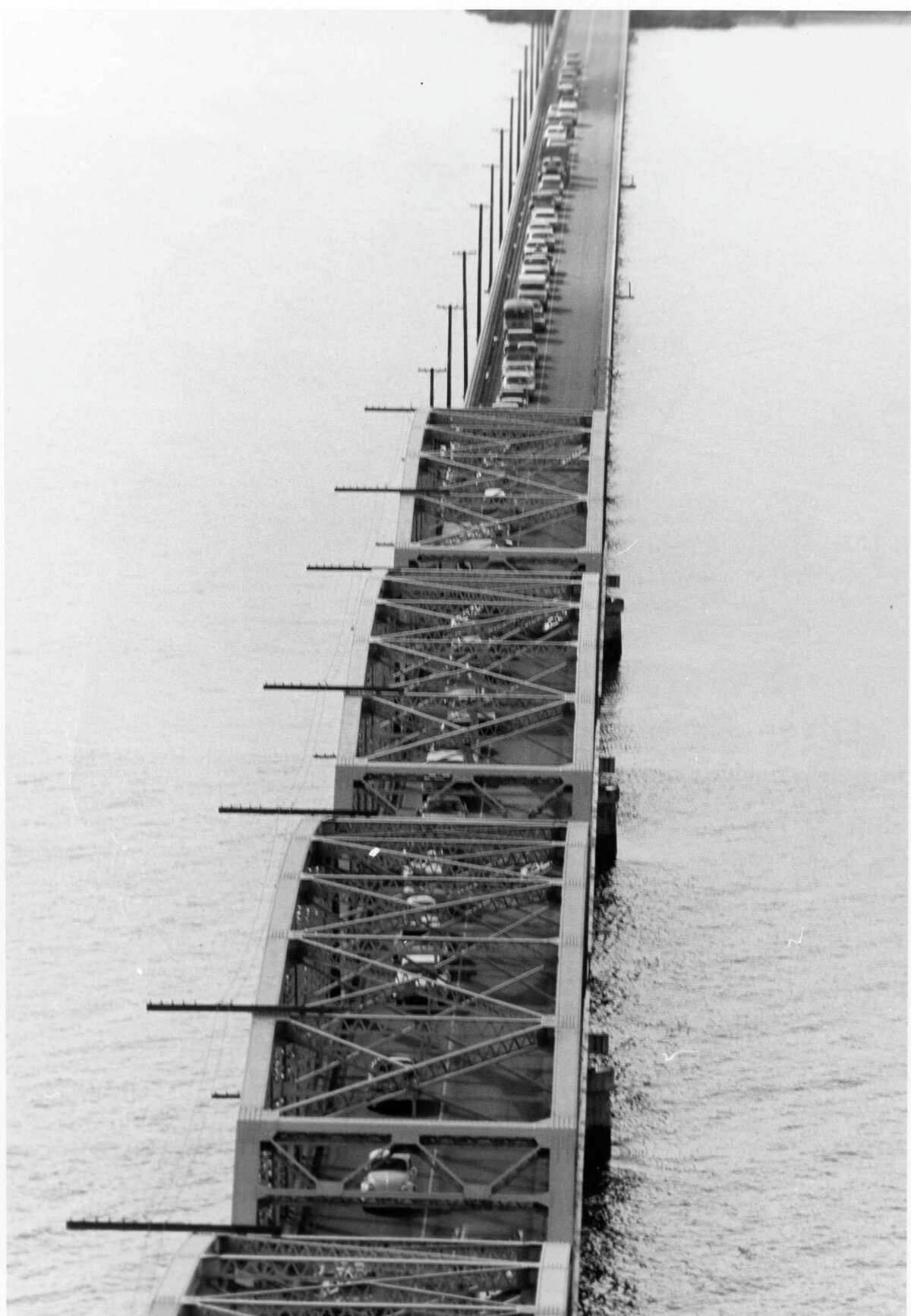 An aerial view of Dumbarton Bridge in 1976 with the drawbridge raised and traffic congested.