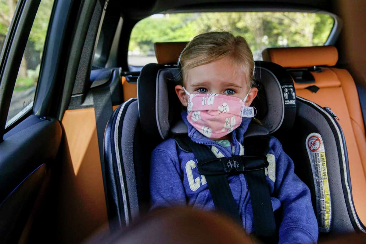 Éala McLaughlin, 4, wears her mask while being driven to school by her mother, Kate, in Santa Rosa, Calif. on Thursday, April 7, 2022.