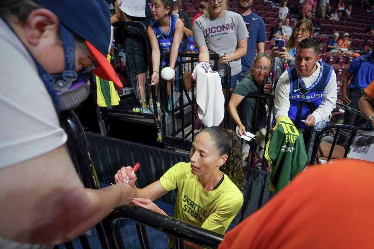 Seattle Storm guard Sue Bird signs autographs before the WNBA basketball game between the Connecticut Sun and the Storm, Thursday, July 28, 2022, in Uncasville, Conn. (AP Photo/Bryan Woolston)