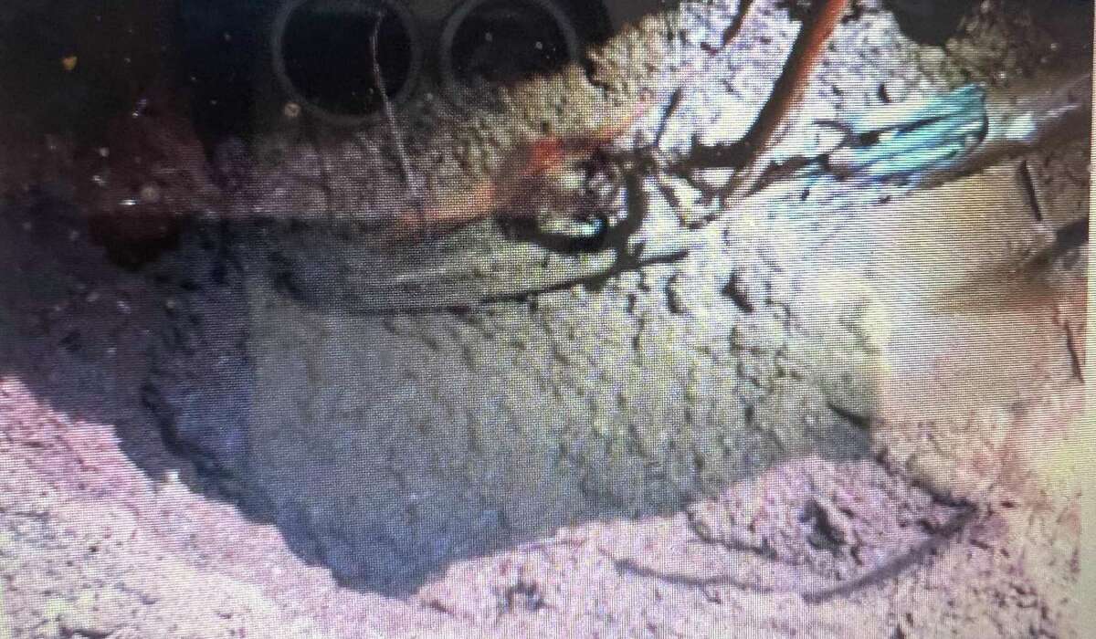 A photo shows the installation of fiberoptic conduit inside of an Eversource electric conduit, which state utility regulators said is not safe. Connecticut regulators said Frontier Communications was responsible for this unsafe practice by a contractor.