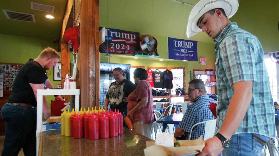 Will Taylor picks up his order during lunch at Trump Burger Thursday, July 28, 2022 in Bellville.