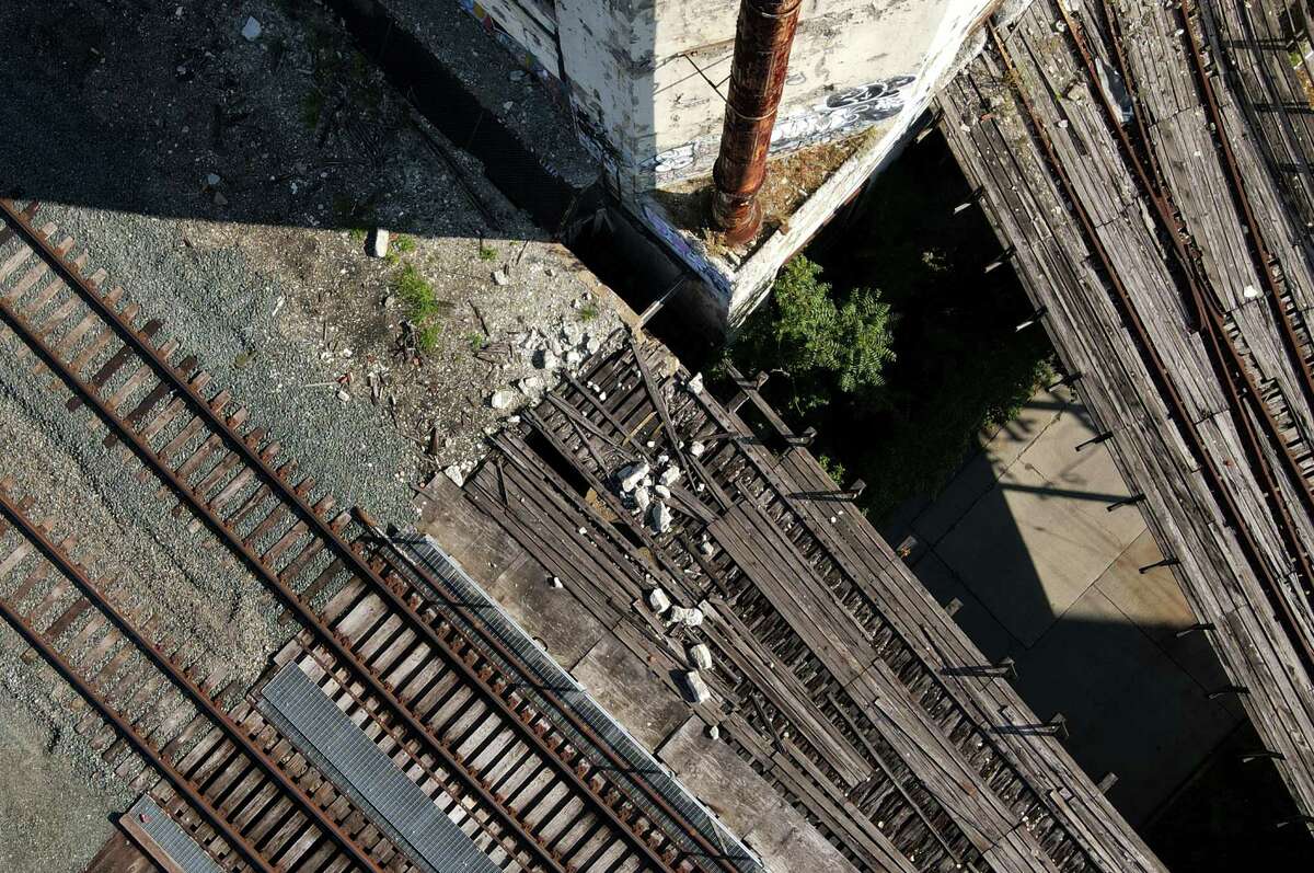 Chucks of concrete that fell from Central Warehouse are seen next to the train tracks used by Amtrak on Friday, July 29, 2022, in Albany, N.Y.