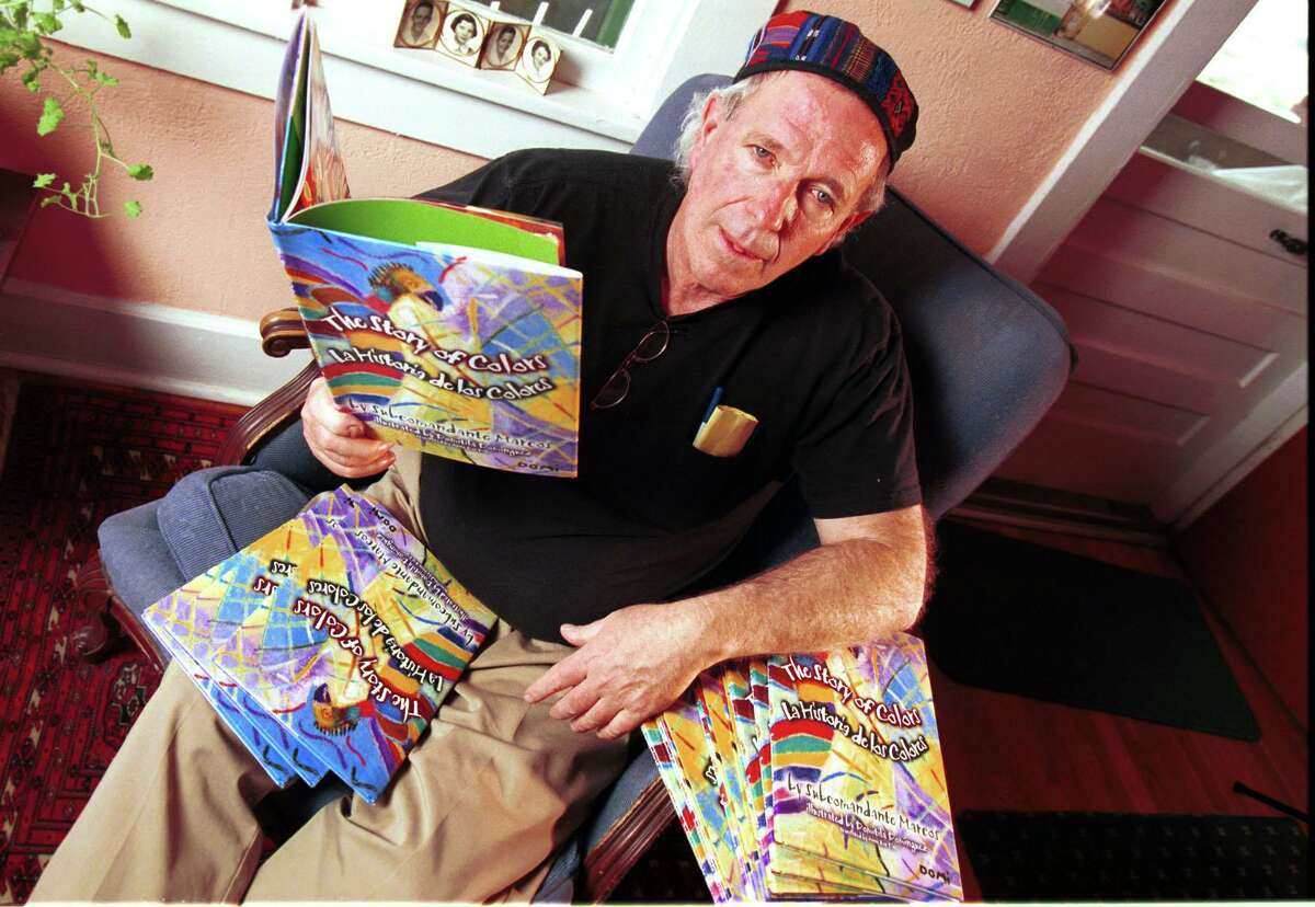 Bobby Byrd sits with the children’s book called “The Story of Colors" by Subcomandante Marcos, perhaps the most controversial book published by Byrd, who ran a publishing company in El Paso called Cinco Puntos Press.