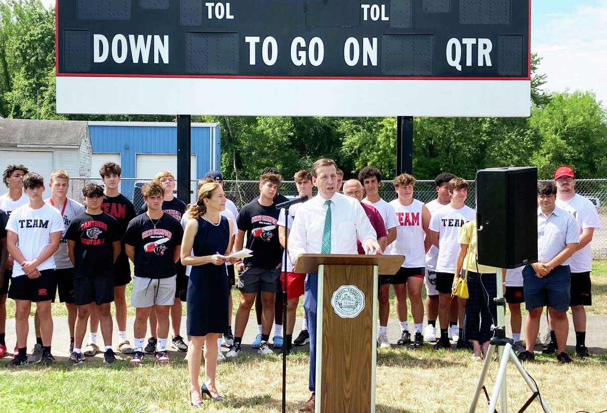 From left, Lt. Gov. Susan Bysiewicz and state Sen. Matt Lesser join Cromwell/Portland Panthers players Friday to herald the State Bond Commission allotting $1.5 million in funding for upgrades to Pierson Park in Cromwell.