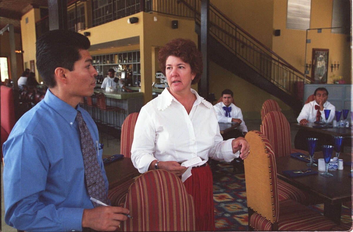 Tracy Vaught (centre) talks to staff before the very first service at Hugo in 2002.