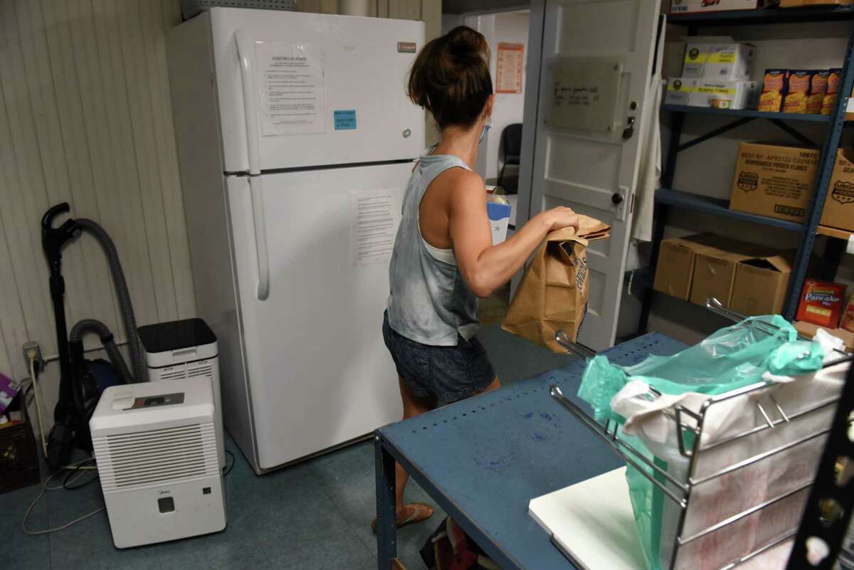 Food selected by a customer is assembled by a volunteer at the Chatham Area Silent Pantry on Friday, July 29, 2022, at Tracy Memorial Village Hall in Chatham, N.Y.