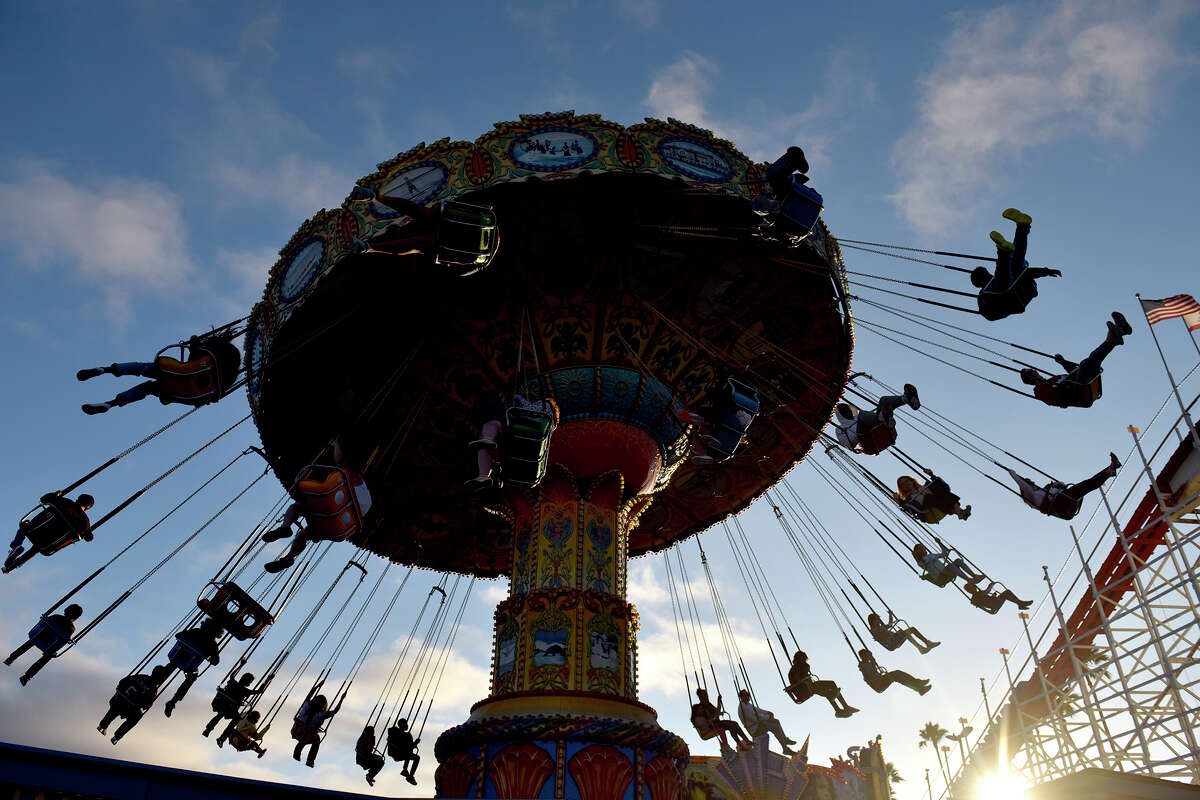 Partygoers on the Santa Cruz boardwalk enjoy a late summer afternoon stroll.