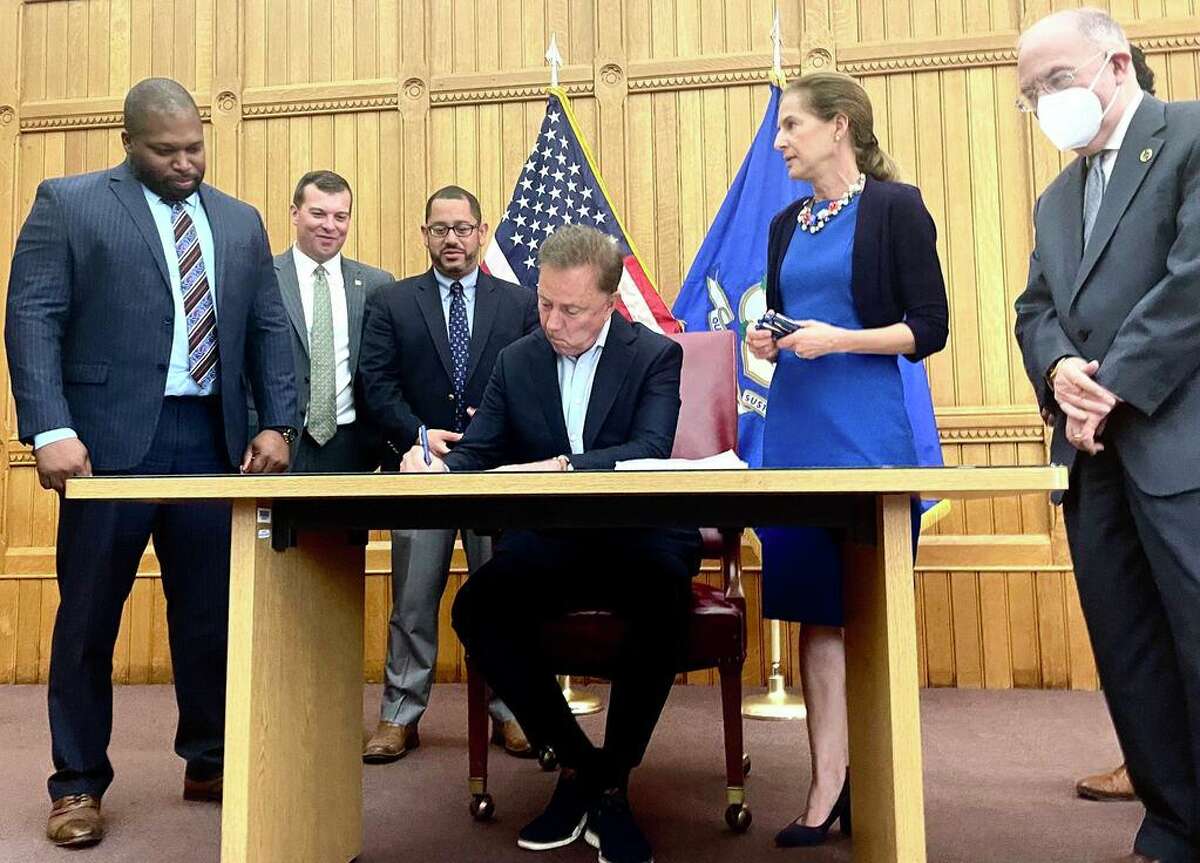 Gov. Ned Lamont signed a bill on Tuesday, June 22 making recreational marijuana legal for adults in Connecticut starting July 1. From left are proponents Sen. Gary Winfield, D-New Haven; Rep.  Steve Stafstrom, D-Bridgeport; House Majority Leader Jason Rojas, D-East Hartford; Lamont; Lt. Gov. Susan Bysiewicz; and Senate President Pro-Tem Martin Looney, D-New Haven.