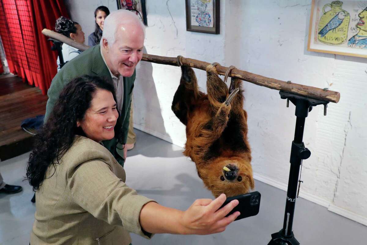 Isabella Casillas Guzman, Administrator of the Small Business Administration, left, and Texas Sen. John Cornyn, middle, take a “slothy” (a selfie with the sloth) with “Curly”, right, the Linnaeus two toed sloth from the Houston Zoo during an event held at The Heights Theater touting the Small Business Administration legislation known as the “Save Our Stages Act” that benefitted area venues during the pandemic Friday, Jul. 29, 2022 in Houston, TX.