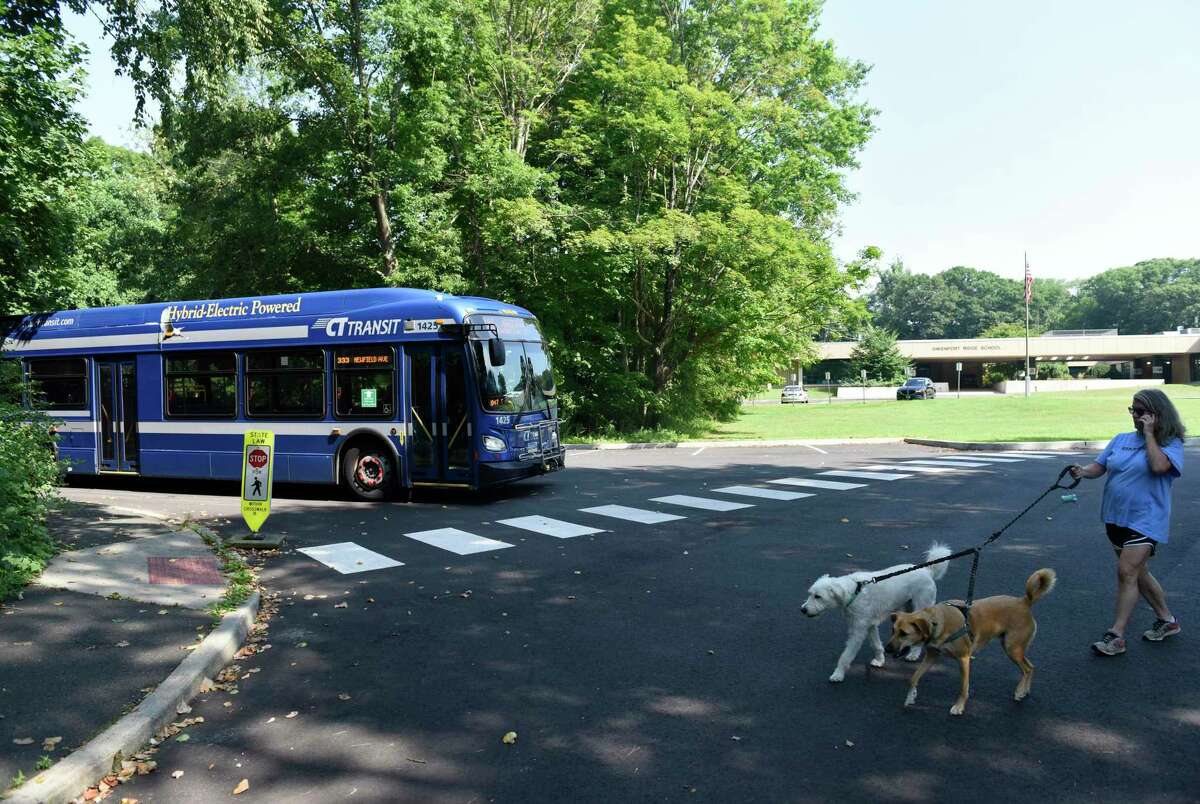 A CTtransit bus pulls up to the bus stop near Davenport Ridge Elementary School in Stamford, Conn. Thursday, July 21 2022. The school was put into lockdown in May when a man got off the bus and attempted to enter the school.