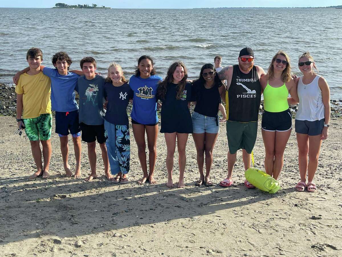 Members of the Trumbull Pisces swim team train for the SWIM Across the Sound, which will take place Aug. 6, 2022. From left to right: Oleksander Kyy, Aaron Dressler, Chasse Reynolds, Keira Citarella, Alexis Abellard, Abby Adams, Anisha Kurup, Coach Bill Strickland, Coach Liz Soelzel, and Coach Jess Daigle. Not pictured: Samara McGlynn and Coach Norah Hampford.