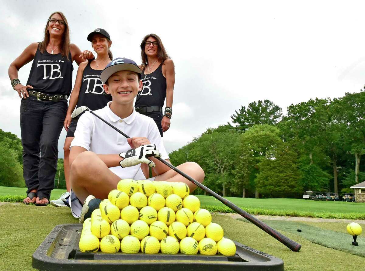 Orange, Connecticut - Monday, August 9, 2021: John Paul Malafronte, 13, front, with his aunts' Mia Malafronte, Nancy Malafronte, and Gina Malafronte, left to right, who organized the "First Chip Malafronte Memorial Golf Tournament For The Boy " at the Race Brook Country Club in Orange Monday. Chip Malafronte, John Paul Malafronte's father was a New Haven Register sportswriter and columnist who died of cancer. The golf tournament is a fundraiser for John Paul Malafronte.