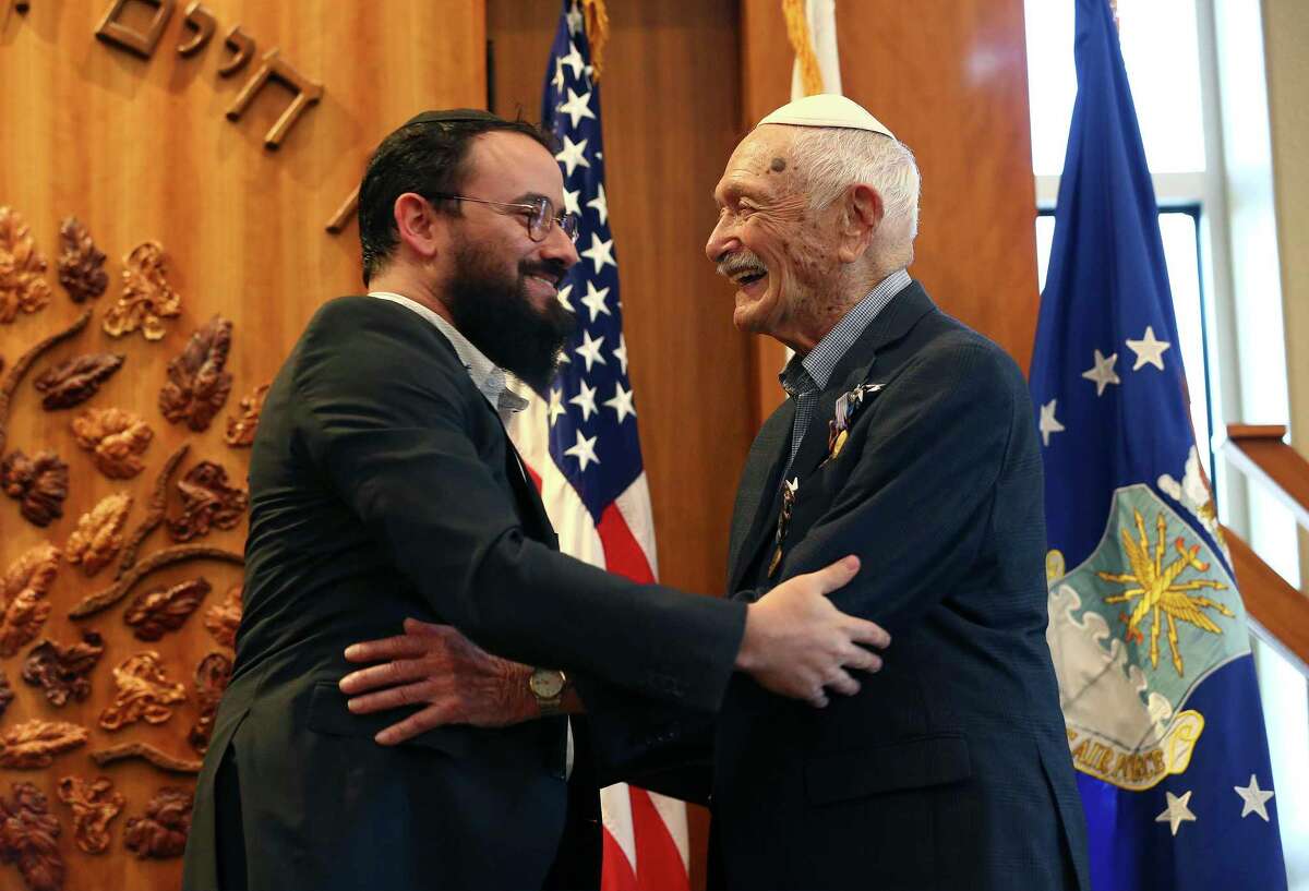 World War II veteran Gerald Teldon, 97, beams after his grandson, Rabbi Moshe Teldon, pins a medal on him at a ceremony Friday. The former fighter pilot was surrounded by more than two dozen family members at the Chabad Center for Jewish Life & Learning.