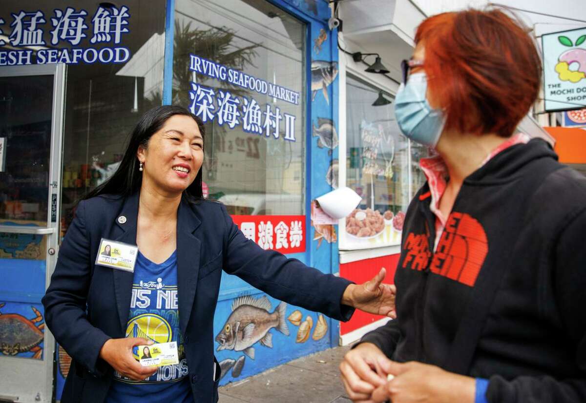 Leanna Louie (left), campaigning for the District Four seat on the Board of Supervisors, chats with resident Amy Lao.