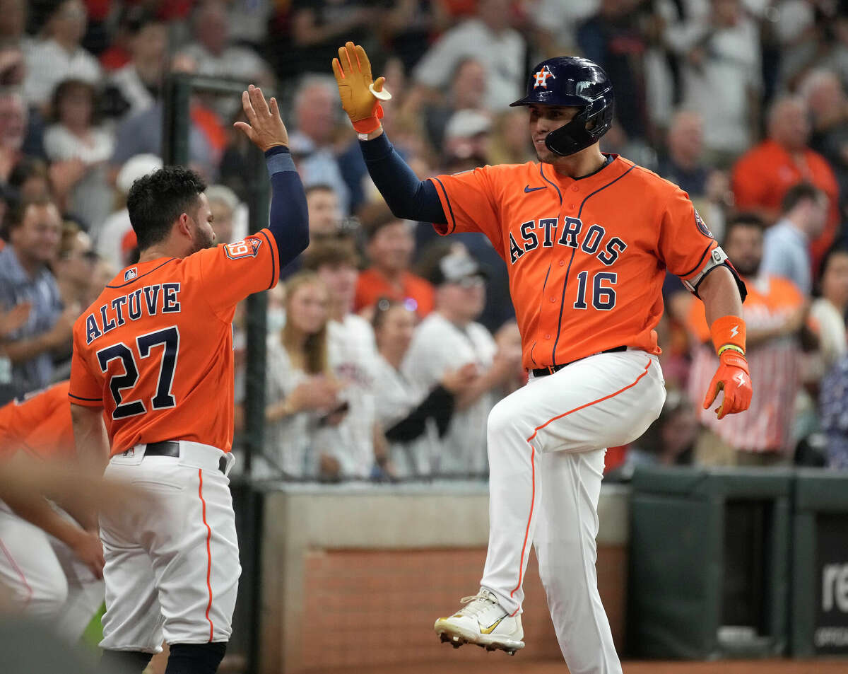 Houston Astros' Aledmys Diaz (16) celebrates his home run off of Seattle Mariners starting pitcher Robbie Ray with Jose Altuve (27) during the second inning of an MLB baseball game at Minute Maid Park on Friday, July 29, 2022 in Houston.