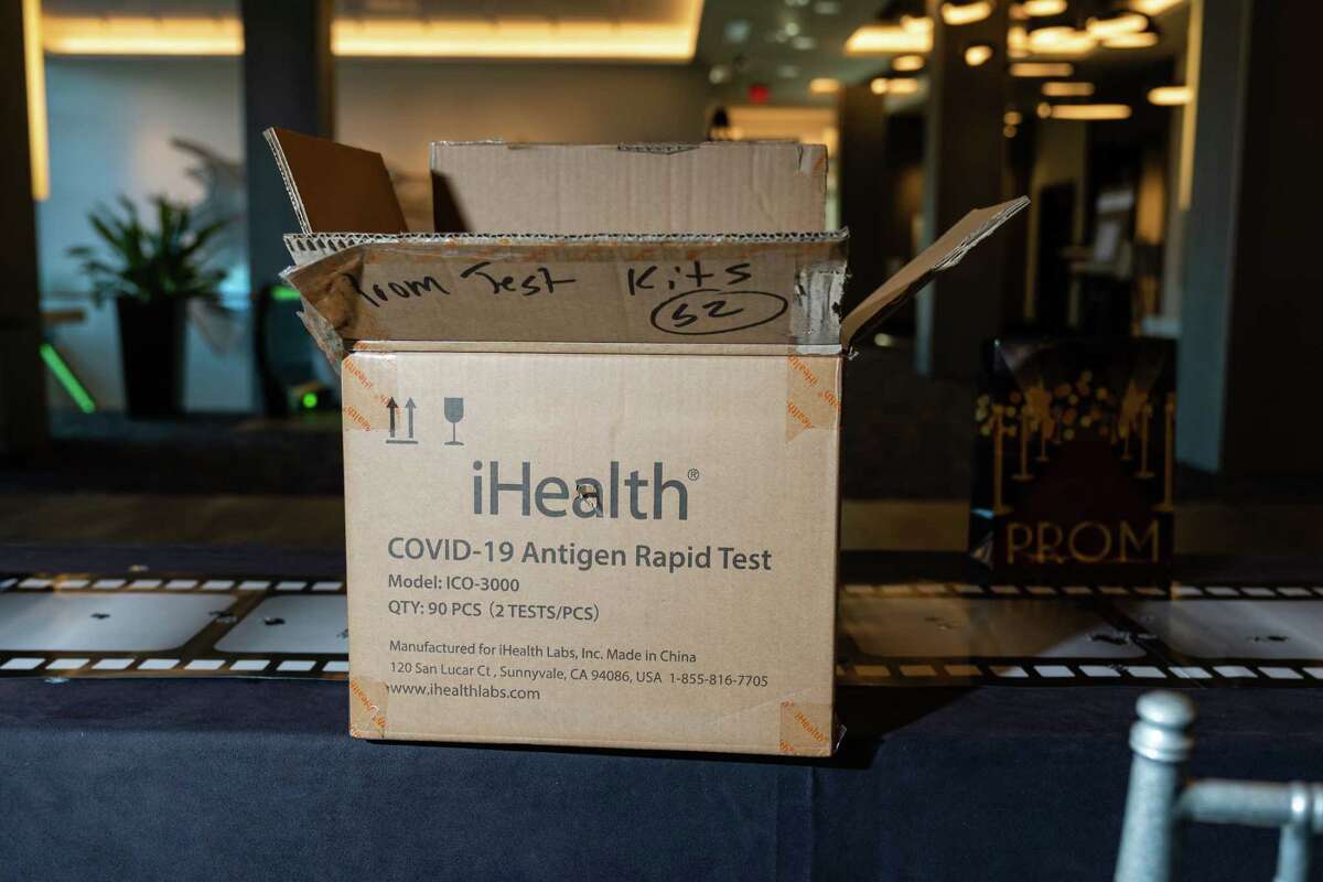 A box of rapid antigen rapid tests sits on a registration table before Charles Herbert Flowers High School's prom at The Hotel at the University of Maryland in College Park, Md., in May.
