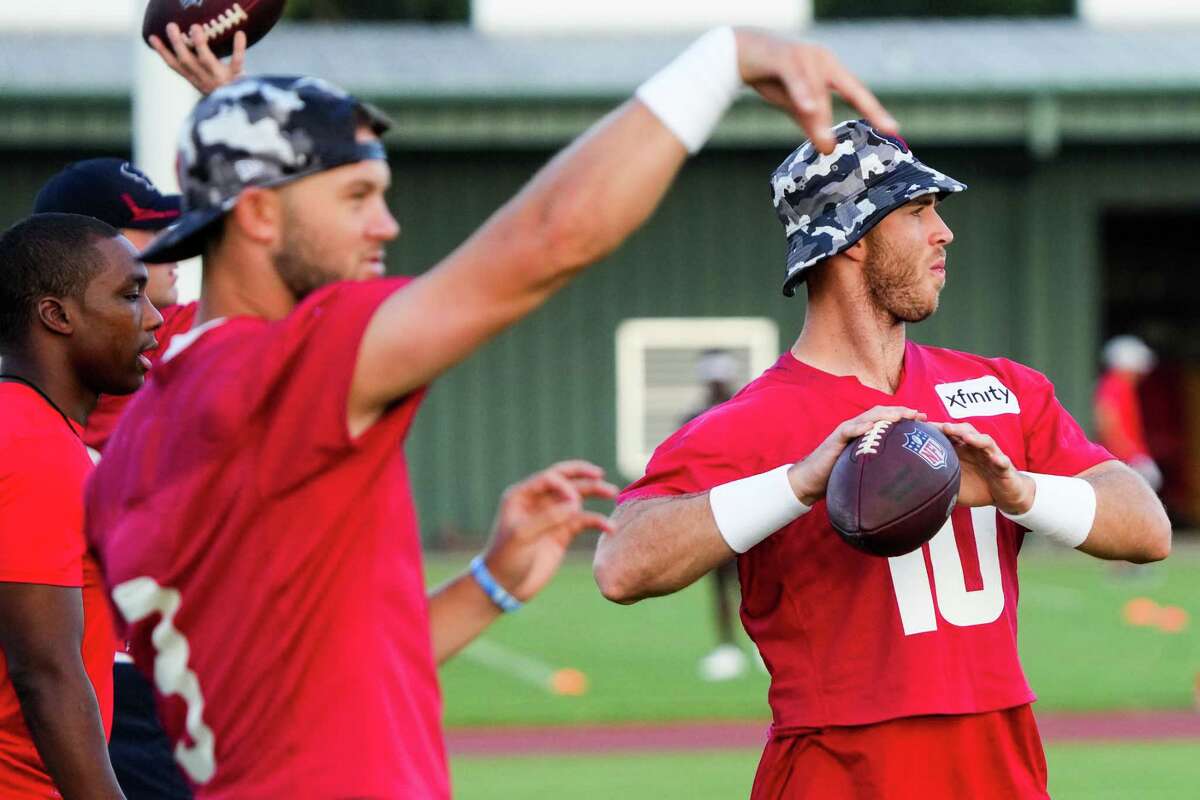 Houston Texans quarterback Davis Mills (10) drops back to throw with the quarterback group during an NFL training camp Saturday, July 30, 2022, in Houston.