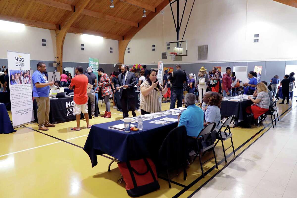 Attendees at a Harris County event with various booth offering services, including public defenders help misdemeanor offenders apply to have their convictions sealed or expunged, held at Victory International Church Saturday, Jul. 30, 2022 in Houston, TX.
