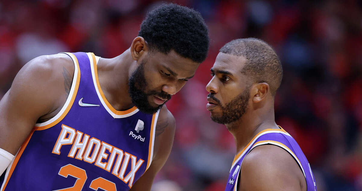 Chris Paul #3 and Deandre Ayton #22 of the Phoenix Suns talk against the New Orleans Pelicans during Game Four of the Western Conference First Round NBA Playoffs at the Smoothie King Center on April 24, 2022 in New Orleans, Louisiana. (Photo by Jonathan Bachman/Getty Images)