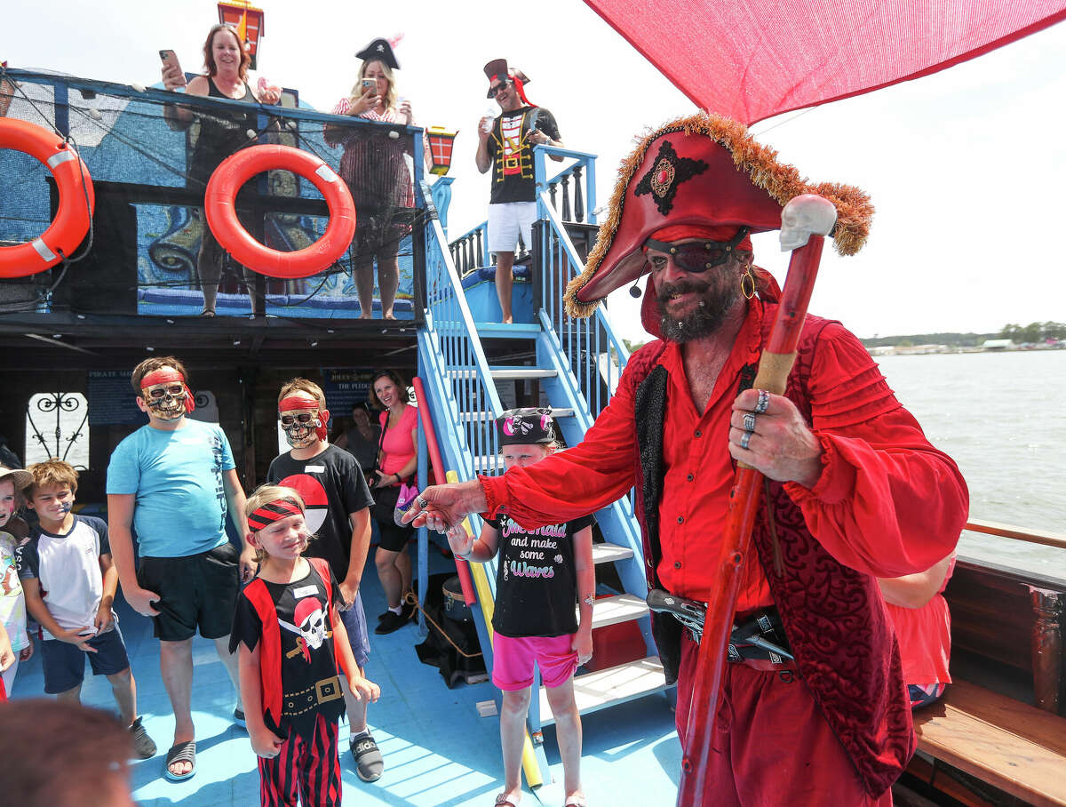 Captain Crimson, played by Tim Morris, regals visitors with a story aboard the Jolly Pirate Ship, a new, 44-foot replica of an ancient galleon, which opened on Lake Conroe, Saturday, July 30, 2022, in Conroe. The ship, operated by 1097 Watersports, offers a 90-minute, family-friendly adventure on the lake.