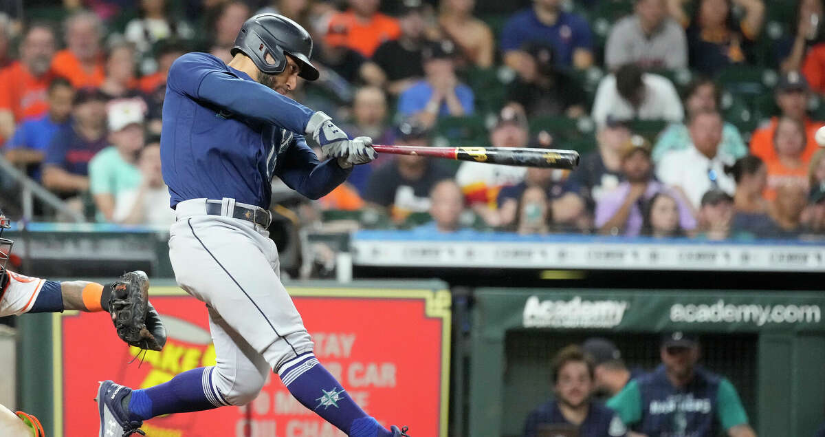 Seattle Mariners' Abraham Toro (13) hits an RBI single against Houston Astros relief pitcher Ryan Pressly during the ninth inning of an MLB baseball game at Minute Maid Park on Saturday, July 30, 2022 in Houston.