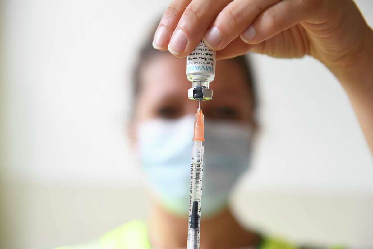 A health professional prepares a dose of a monkeypox vaccine on July 27, 2022. While the risk of exposure to monkeypox remains low, health experts say college students living in close proximity to each other could spur outbreaks. They encourage schools to share their plans and relevant information about the virus.