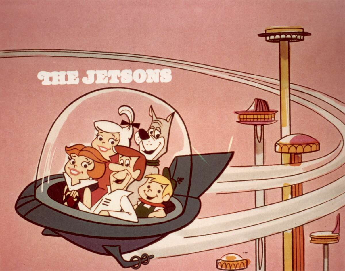 circa 1962: Cartoon family the Jetsons, comprised of George, Jane, Judy, Elroy, and Astro, flying in a space car in a space age city, in a still from the Hanna-Barbera animated television show, 'The Jetsons'. (Photo by Hulton Archive/Getty Images)