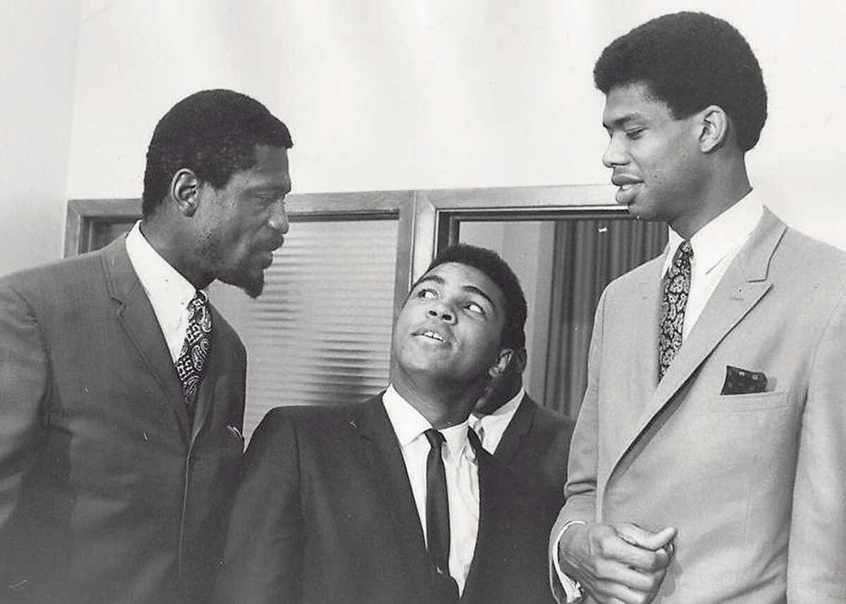 At a meeting of the Negro Industrial and Economic Union organized by football great Jim Brown, a group of top African American athletes from different sporting disciplines gathered to give support and hear the boxer Muhammad Ali give his reasons for rejecting the draft during the Vietnam War, Cleveland, June 4, 1967. Left to right, basketball player Bill Russell, boxing champ Muhammad Ali, and basketball player Kareem Abdul Jabbar. (Photo by Robert Abbott Sengstacke/Getty Images)
