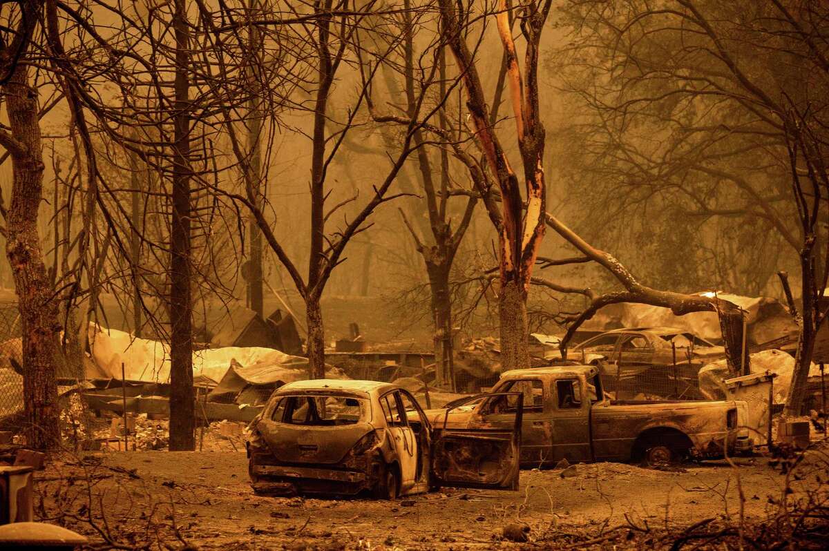Scorched vehicles and residences line the Oaks Mobile Home Park in the Klamath River community as the McKinney Fire burns in Klamath National Forest, Calif., Saturday, July 30, 2022.