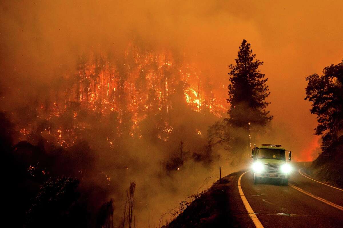 A fire truck drives along California Highway 96 as the McKinney Fire burns in Klamath National Forest on July 30, 2022.