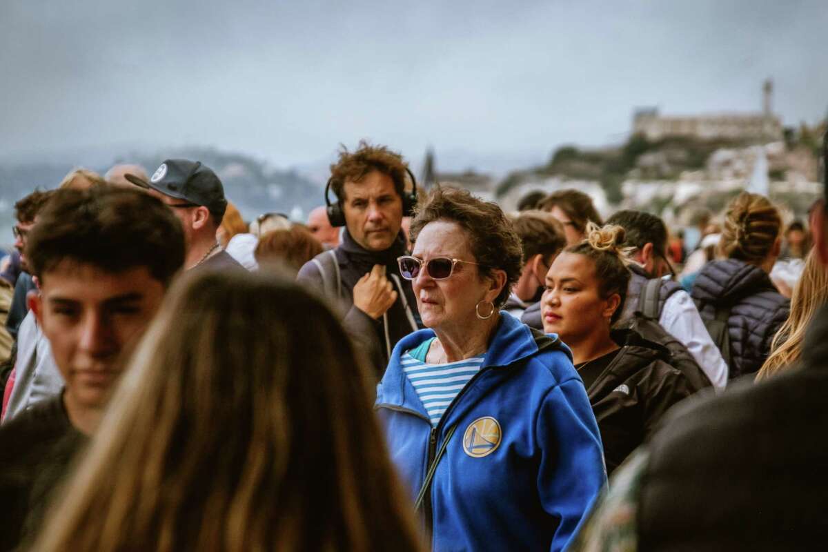 Alcatraz is in the background of a busy Pier 39 in San Francisco in July.