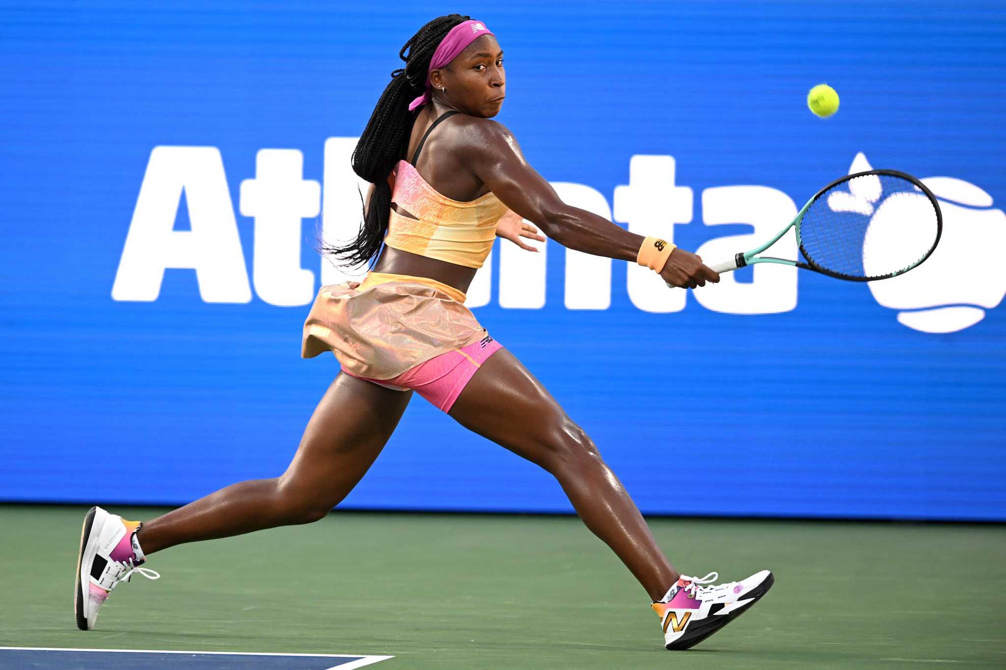 coco recieving a ball in a tennis match