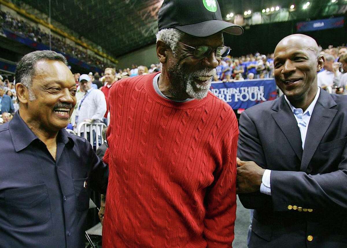 Russell talks with the Rev. Jesse Jackson and fellow NBA Hall of Famer Clyde Drexler before an NCAA game in 2008.