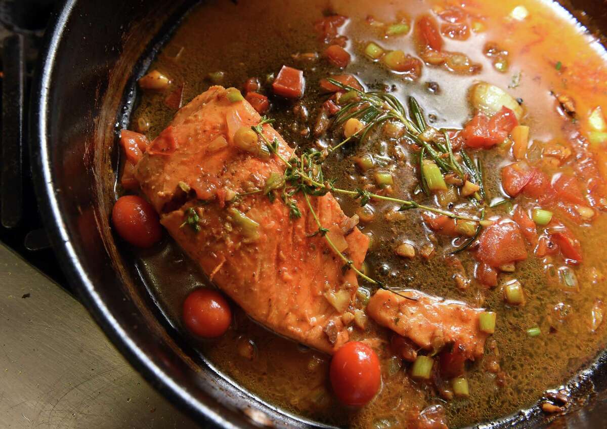 Cho Salmon, coconut salmon in a light curry sauce, is made in the kitchen by Island Cho co-owner Gillian Webb in the new Caribbean restaurant on Washington Avenue in North Haven.