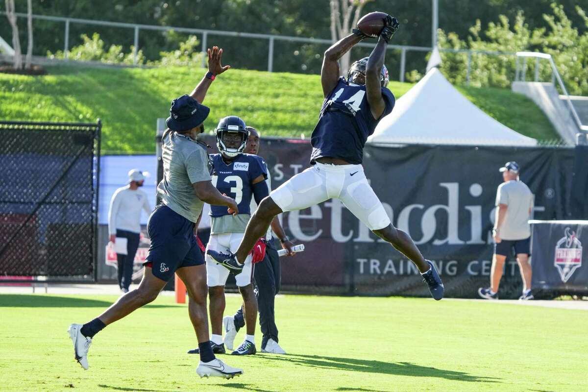 Houston Texans wide receiver Davion Davis (14) leaps to make a catch during an NFL training camp Monday, Aug. 1, 2022, in Houston.