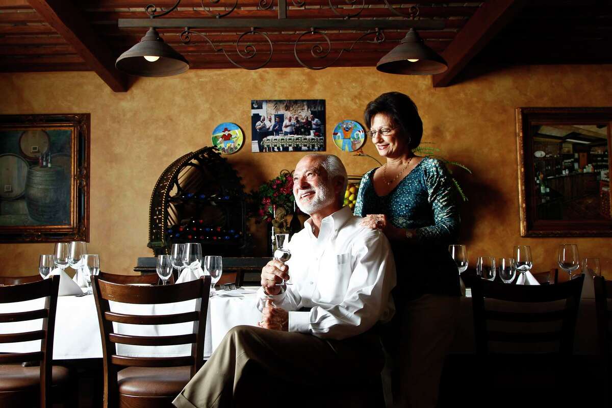 The late Vincent Mandola and his wife Mary, sit inside their restaurant, Grappino di Nino. The Vincent Mandola Family Restaurants announced Monday that after 45 years of service it will close Nino’s, Vincent’s, and Grappino di Nino on Aug. 5.