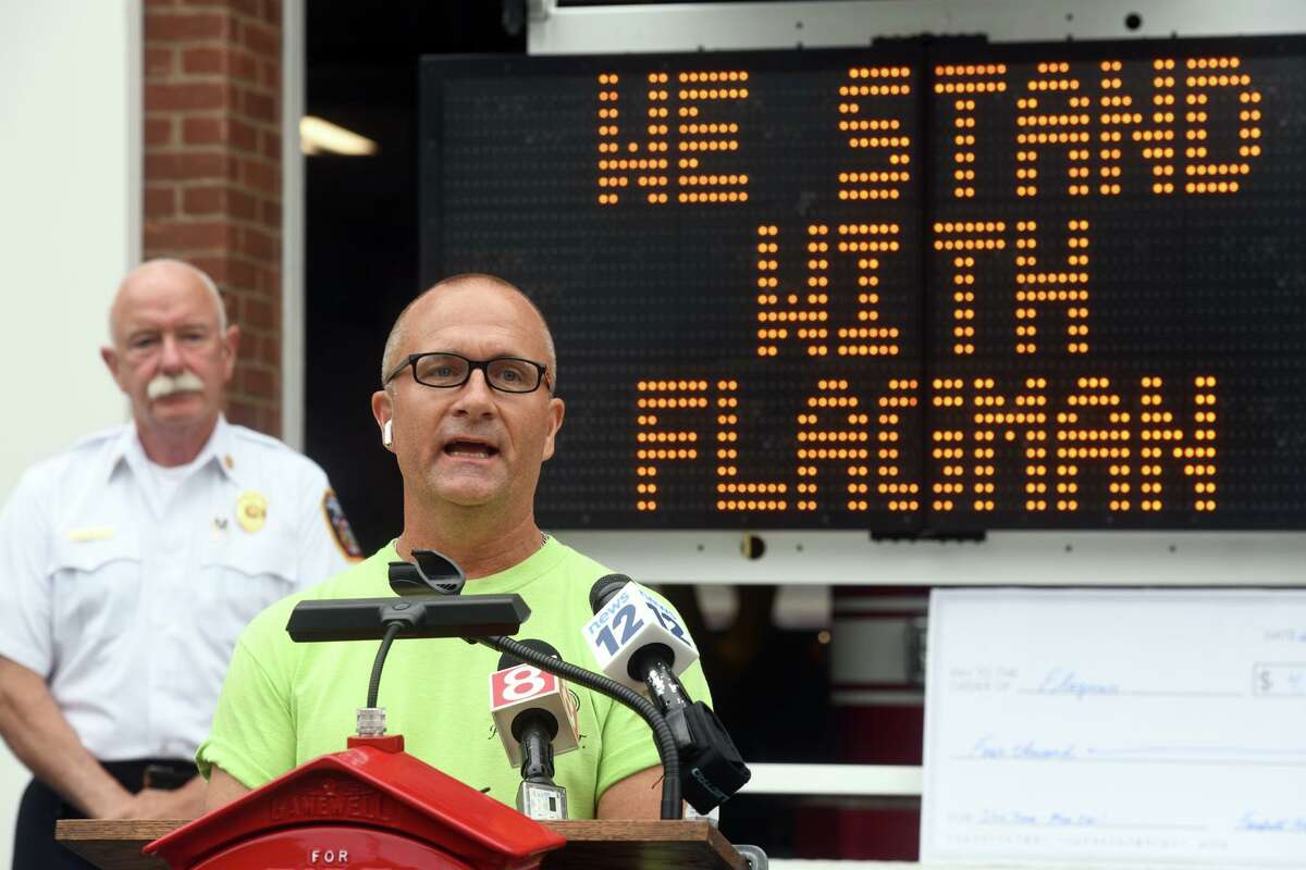 Chris Iodice, brother of Corey Iodice, speaks at a news conference in front of Fire Headquarters, in Fairfield, Conn. Aug. 1, 2022. Iodice joined U.S. Sen. Richard Blumenthal and others to accept a $4000 donation on behalf of the Flagman Project, a foundation started in Corey’s memory. Corey Iodice, a tow truck operator, was killed on the Merritt Parkway while assisting a disabled motorist in 2020.