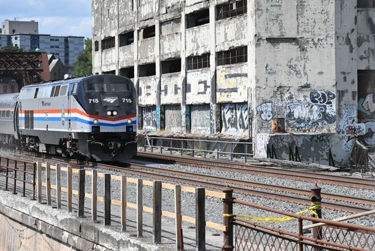 Amtrak trains began rolling past the derelict Central Warehouse Monday afternoon, restoring services that typically carry as many as 2,000 passengers a day.
