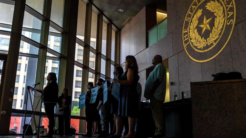 People with the Texas Freedom Network hold a press conference Monday, Aug. 1, 2022, outside the State Board of Education special board meeting at the William B. Travis Building in Austin. The board was hearing public testimony and discussing updates to the state’s social studies curriculum.
