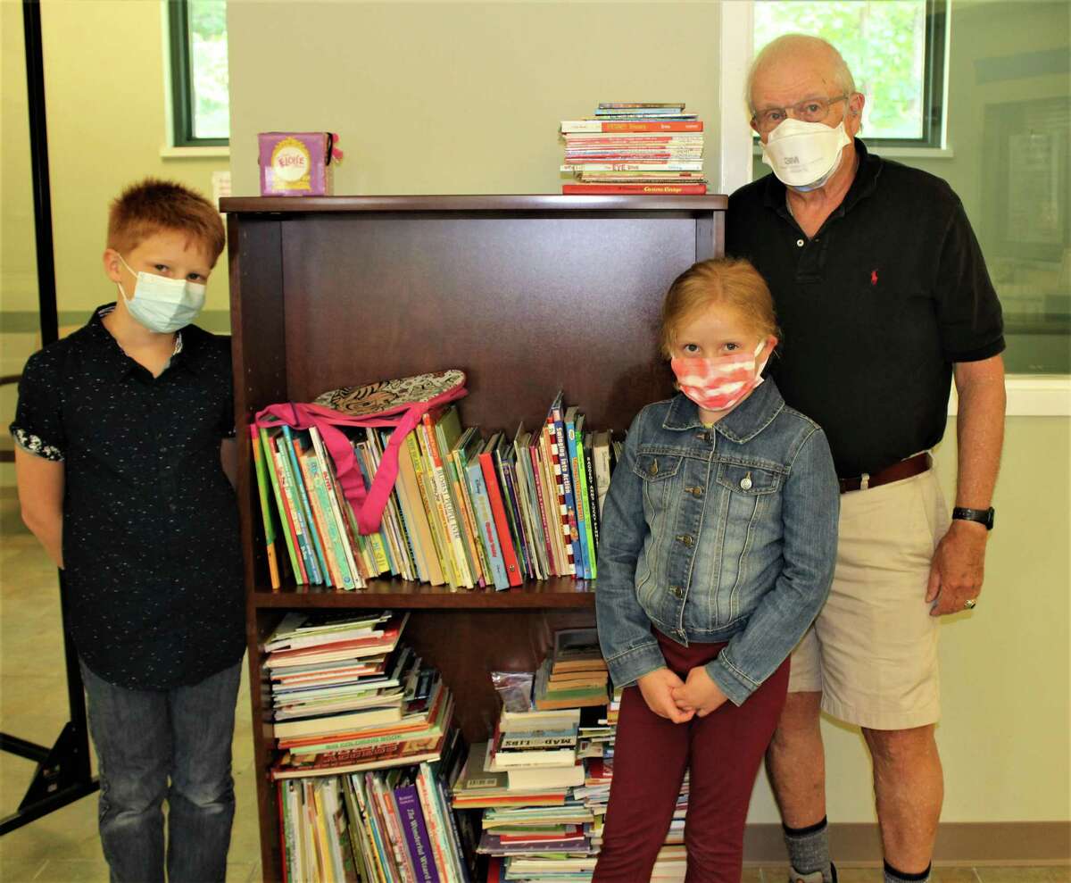 Ophthalmologist Dr. Ronald Berger, who retired from Community Health & Wellness Center, and his grandchildren Sacha and Adele Fortier, collected and donated more than 500 gently loved children’s books for the center’s patients to take home and enjoy.