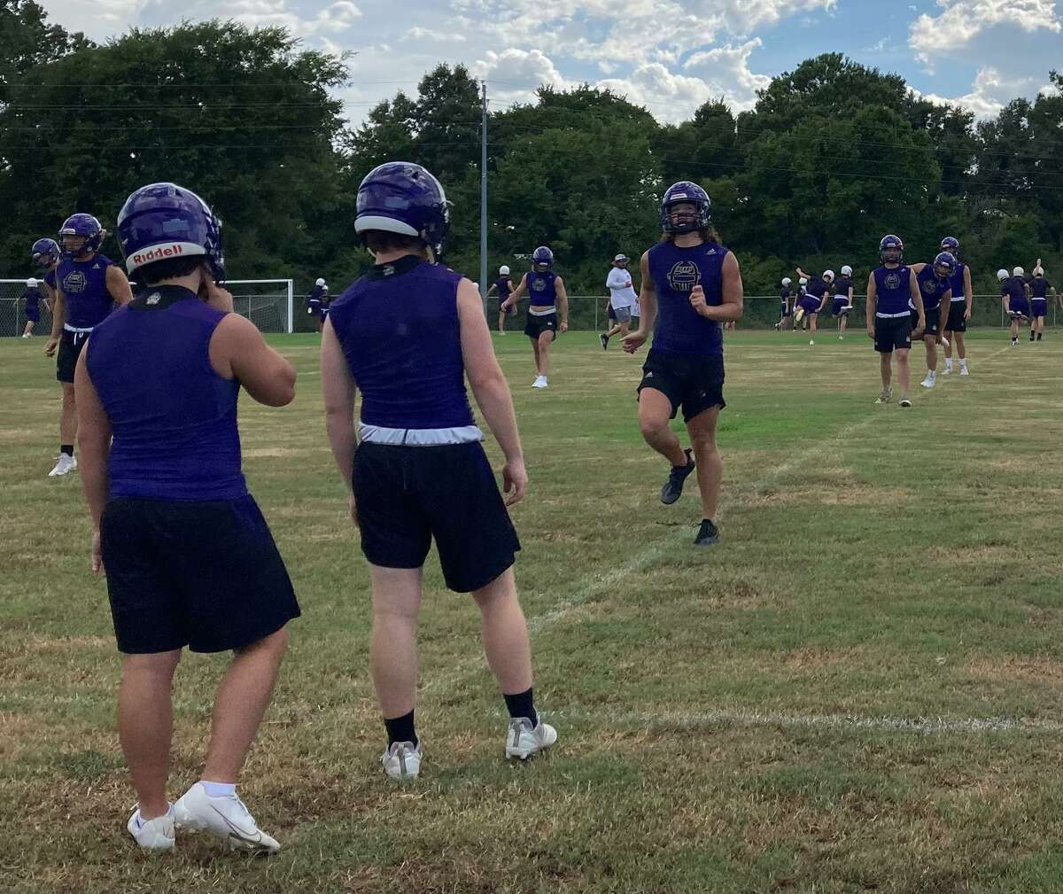 Montgomery football players warm up during the first day of football practice, Monday August 1, 2022, at Montgomery High School.
