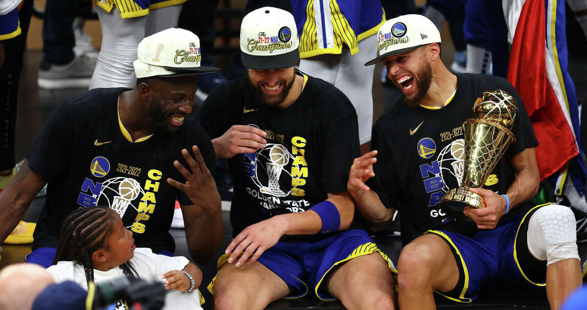 Draymond Green #23, Klay Thompson #11 and Stephen Curry #30 of the Golden State Warriors laugh together after defeating the Boston Celtics 103-90 in Game Six of the 2022 NBA Finals at TD Garden on June 16, 2022 in Boston, Massachusetts. (Photo by Adam Glanzman/Getty Images)