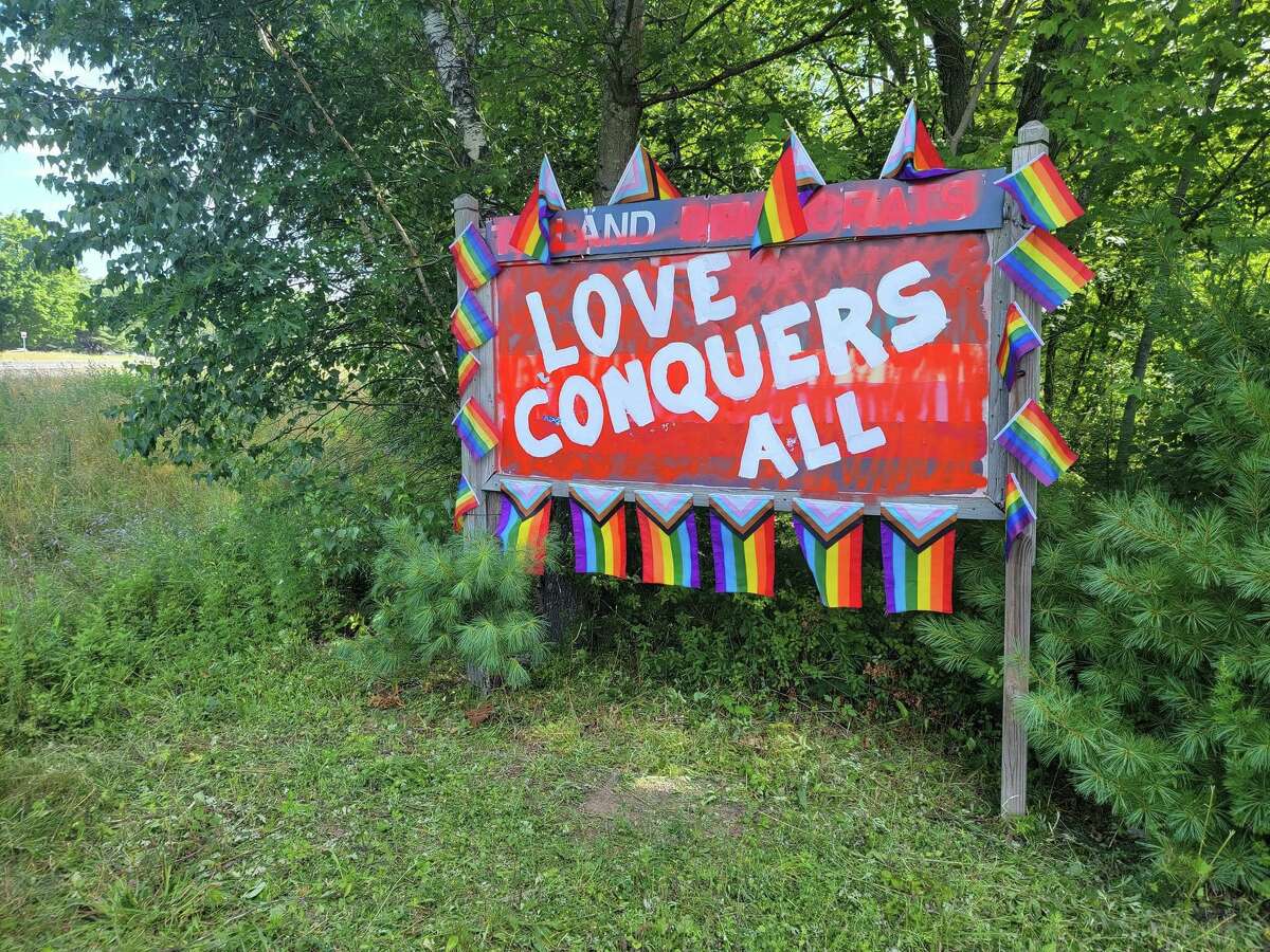 After the Pride flag sign on Merrow Road in Tolland was vandalized, some volunteers got together to repair the sign.