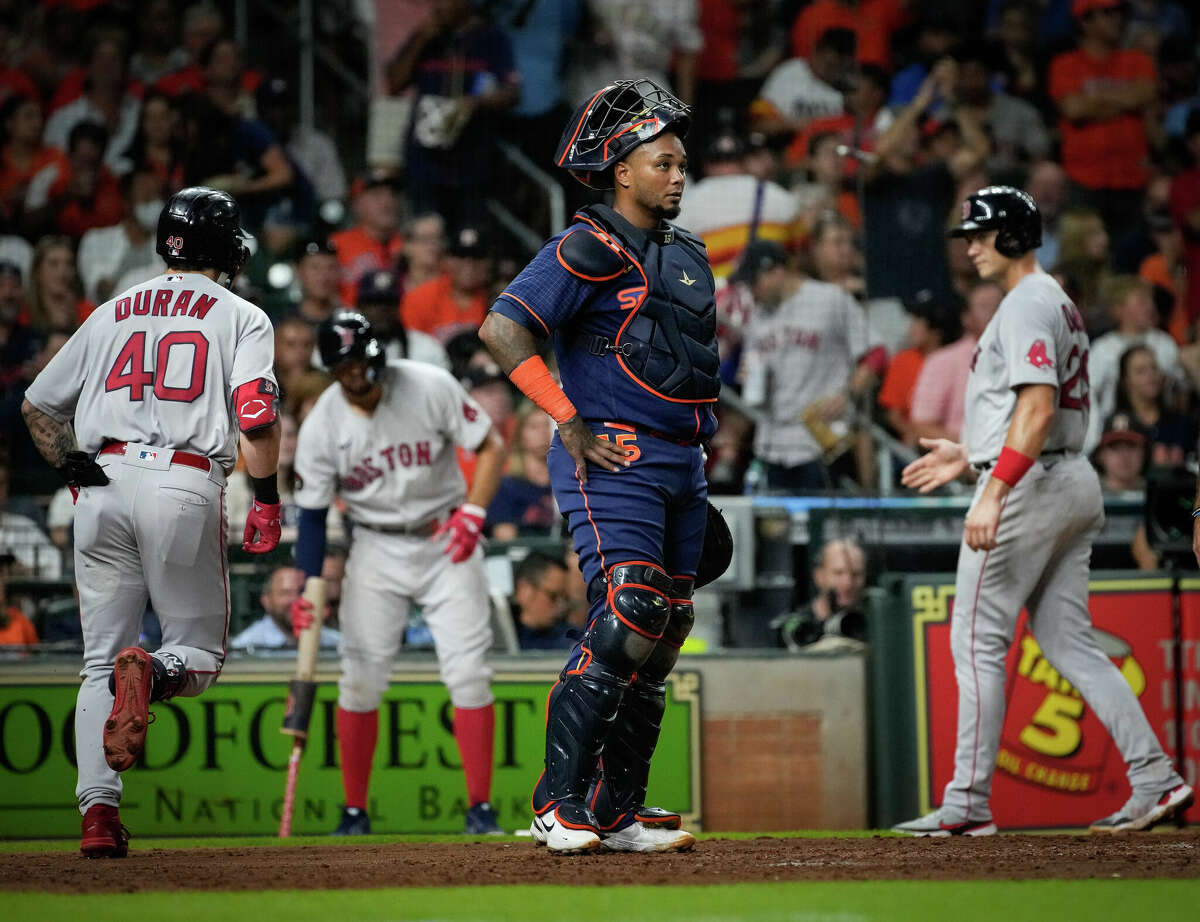 Houston Astros catcher Marti­n Maldonado (15) reacts as Boston Red Sox first baseman Bobby Dalbec (29) scores after hitting a two-run home run during the fifth inning of an MLB game Monday, Aug. 1, 2022, at Minute Maid Park in Houston.