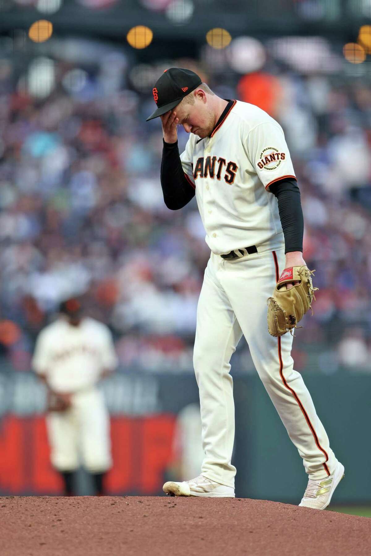 San Francisco Giants' Logan Webb wears a hat and shirt for first baseman  Brandon Belt before a baseball game between the Giants and the Arizona  Diamondbacks in San Francisco, Wednesday, Sept. 29