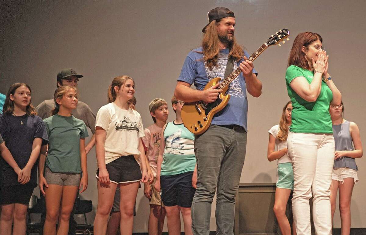 Cast members from Curtains Theater Company rehearse for their encore production of “School of Rock,” scheduled for Aug. 12-14 at Roxana Nazarene Theater.