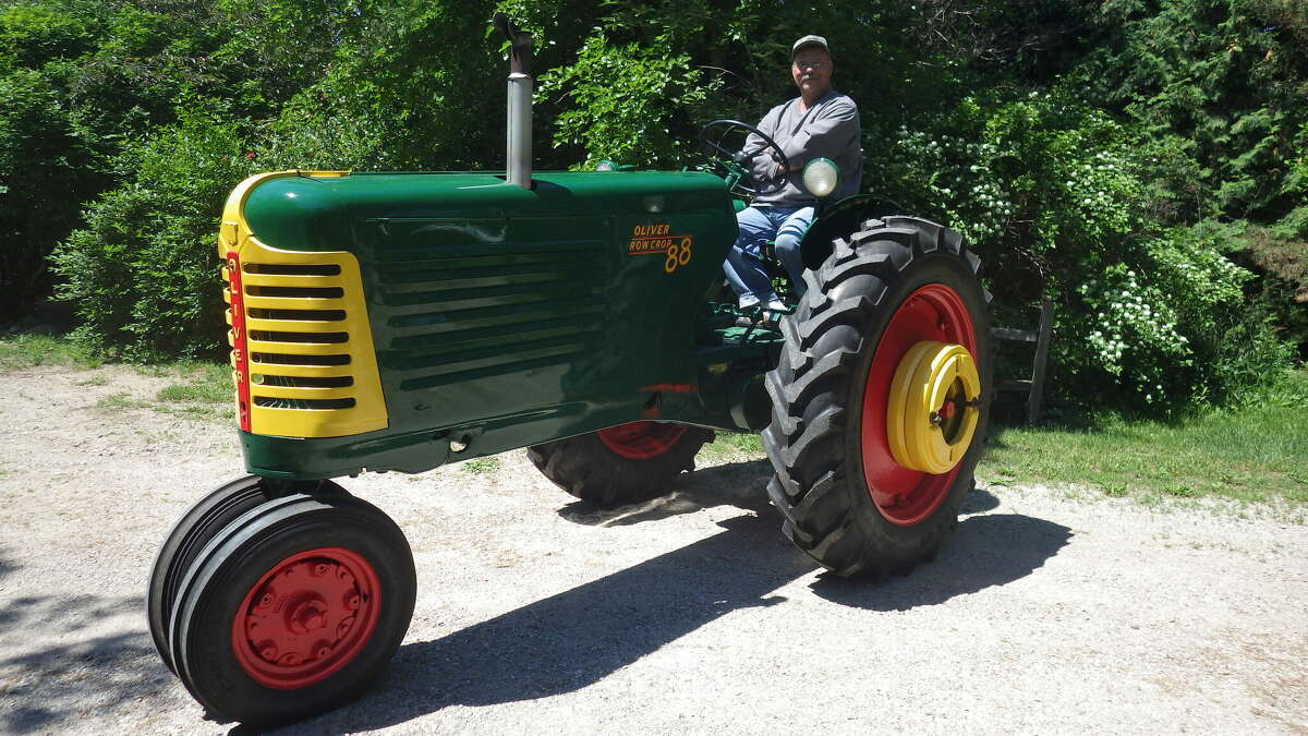 Tom Lounsbury admires his freshly refurbished 1953 Oliver "88 Row Crop" tractor, which he nicknamed "Ollie" when he was a kid.