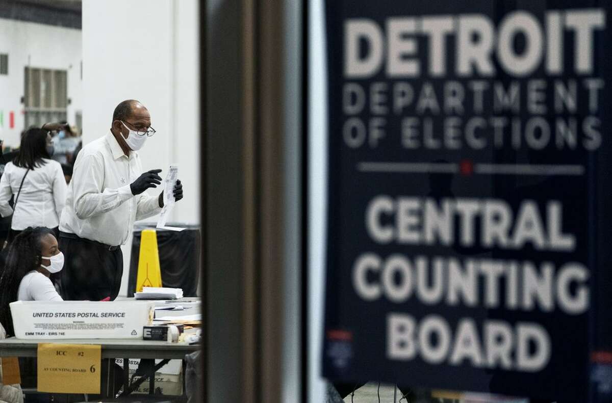 FILE - Election inspectors count ballots into the early morning hours of Wednesday, Nov. 4, 2020, at the central counting board in Detroit.