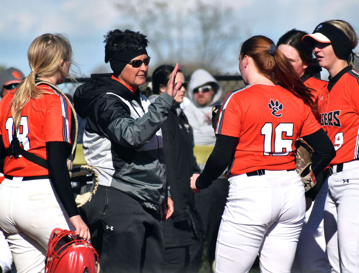 Edwardsville coach Lori Blade (middle) meets with her team during a game in April at Edwardsville.